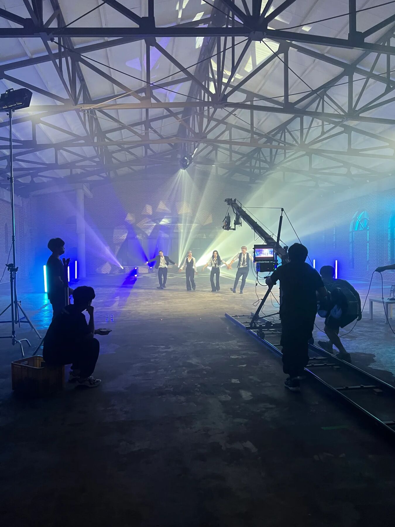 Behind the scenes of a music video shoot on a StageKnot sound stage in Korea, crane camera and dancers