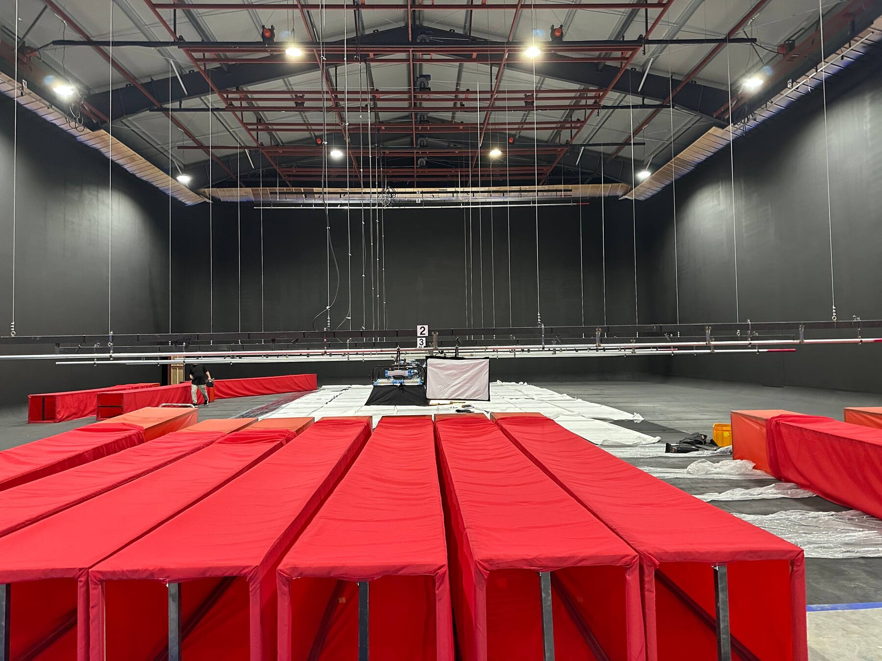 Red upholstered riser benches being installed