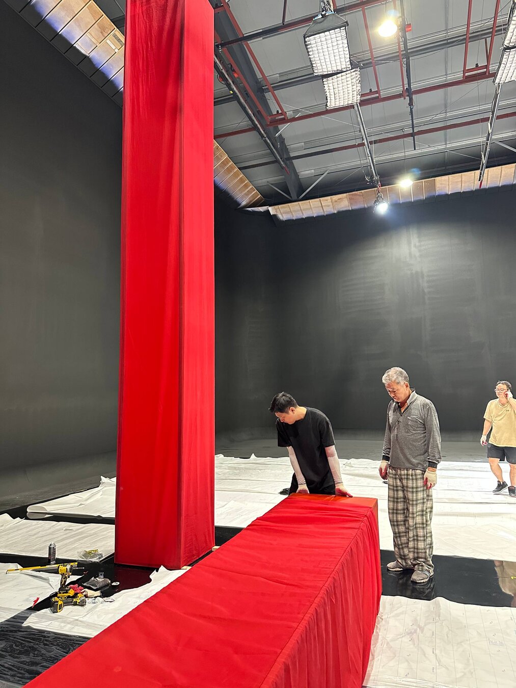 Crew installing a tall red fabric column