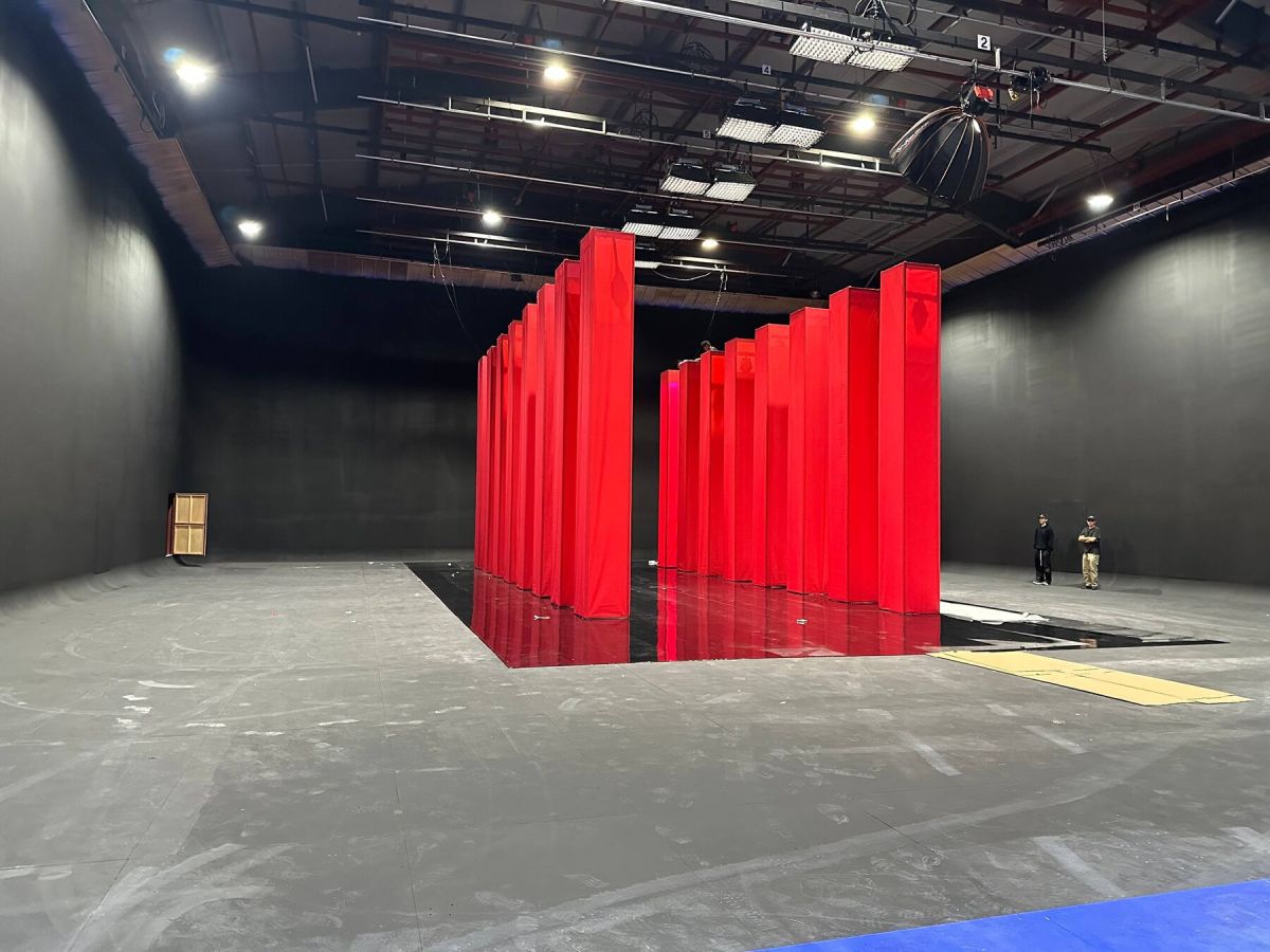 Finished black box stage with red columns lit for production