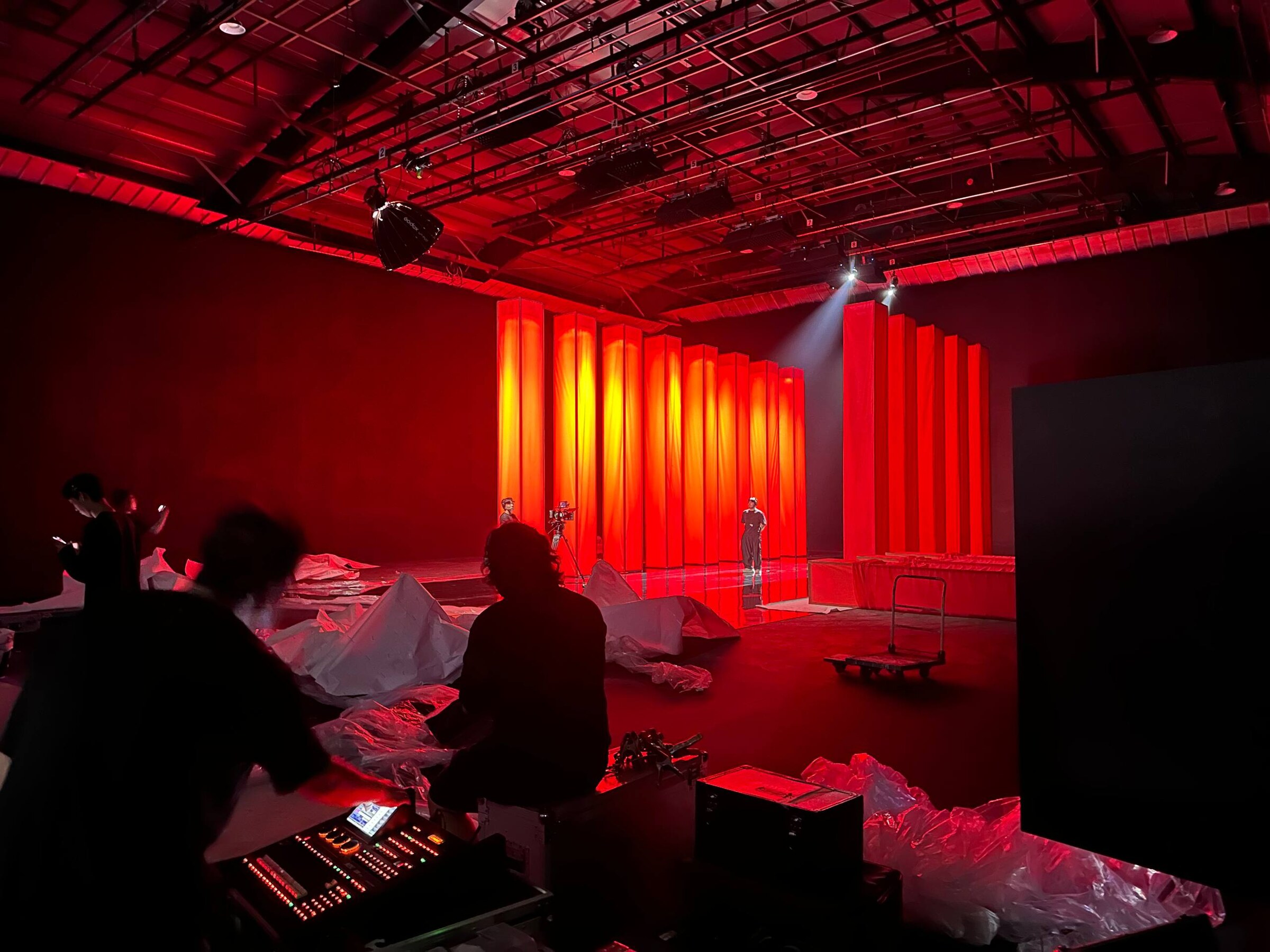 Crew filming inside a StageKnot Seoul soundstage lit in dramatic red and gold