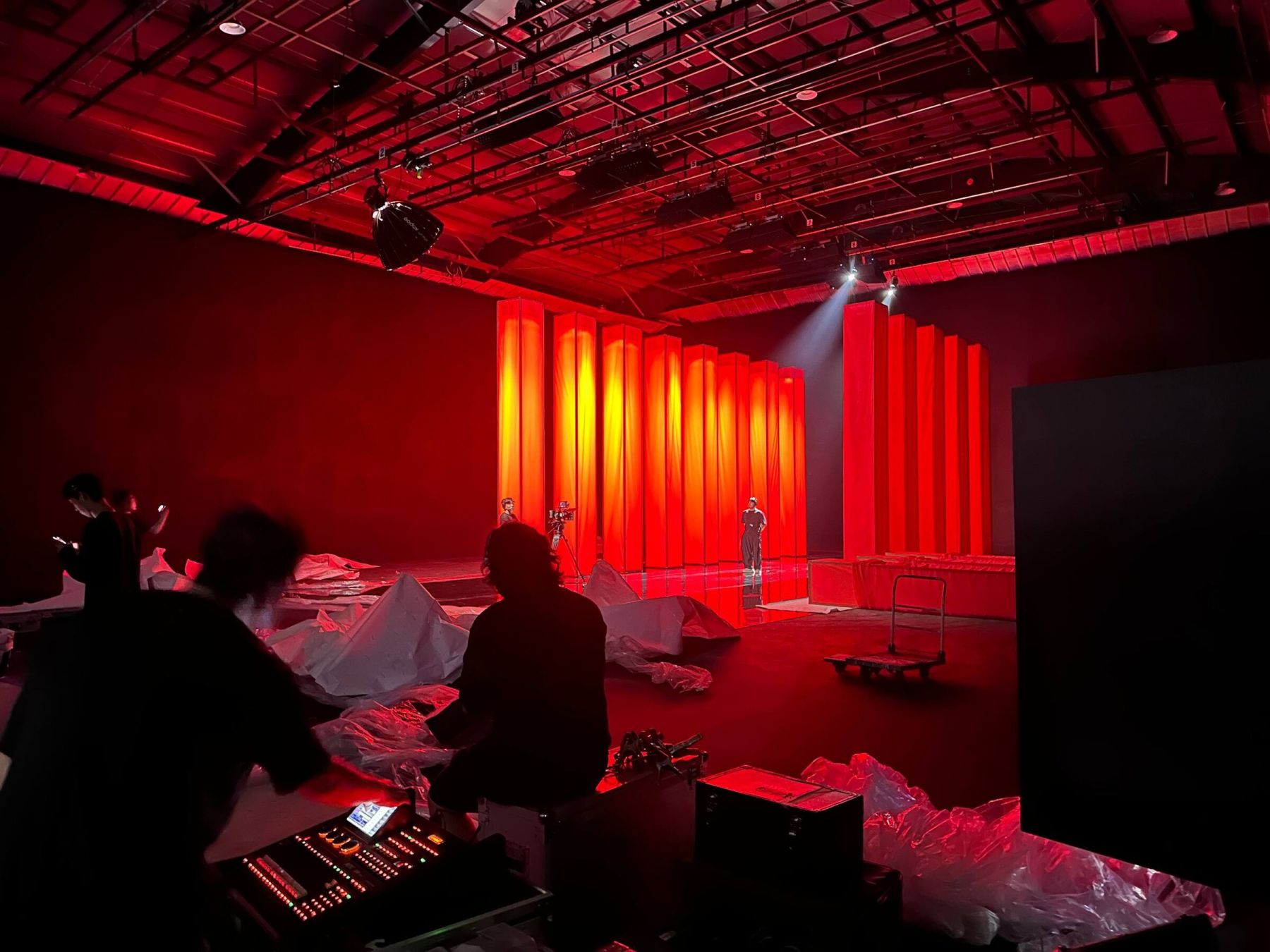 Crew filming inside a StageKnot Seoul soundstage lit in dramatic red and gold
