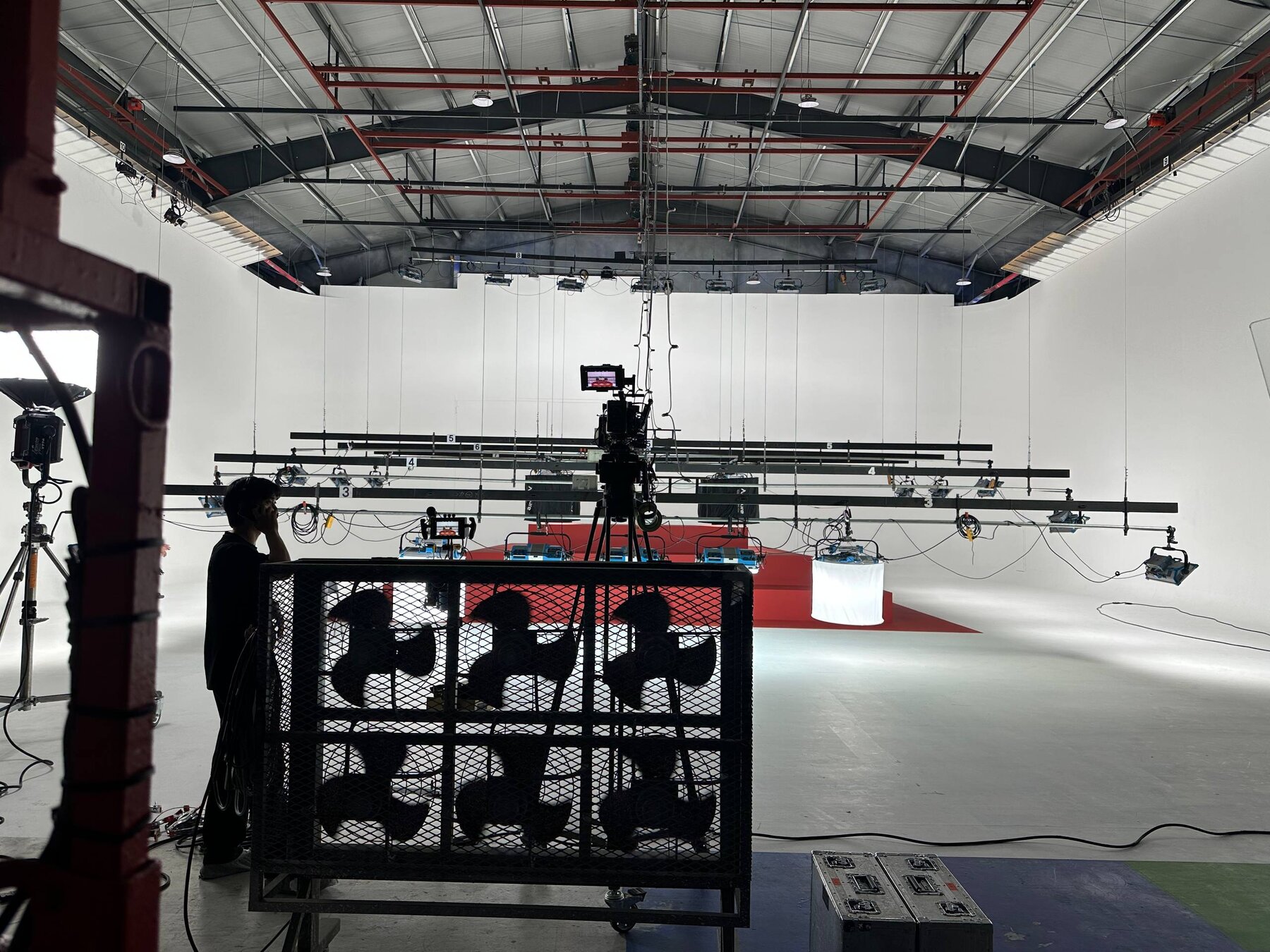 Completed red stair pyramid set on a white cyclorama, ready for production