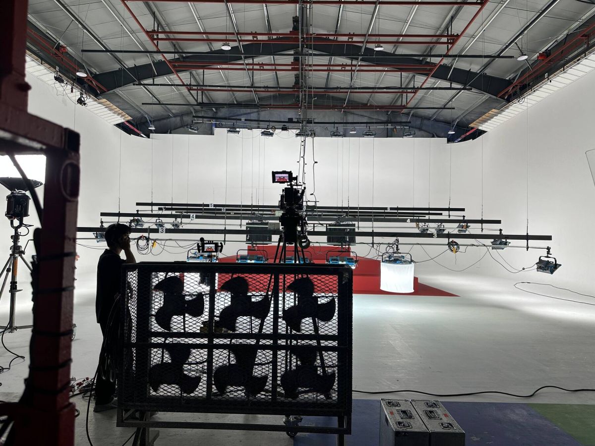 Completed red stair pyramid set on a white cyclorama, ready for production